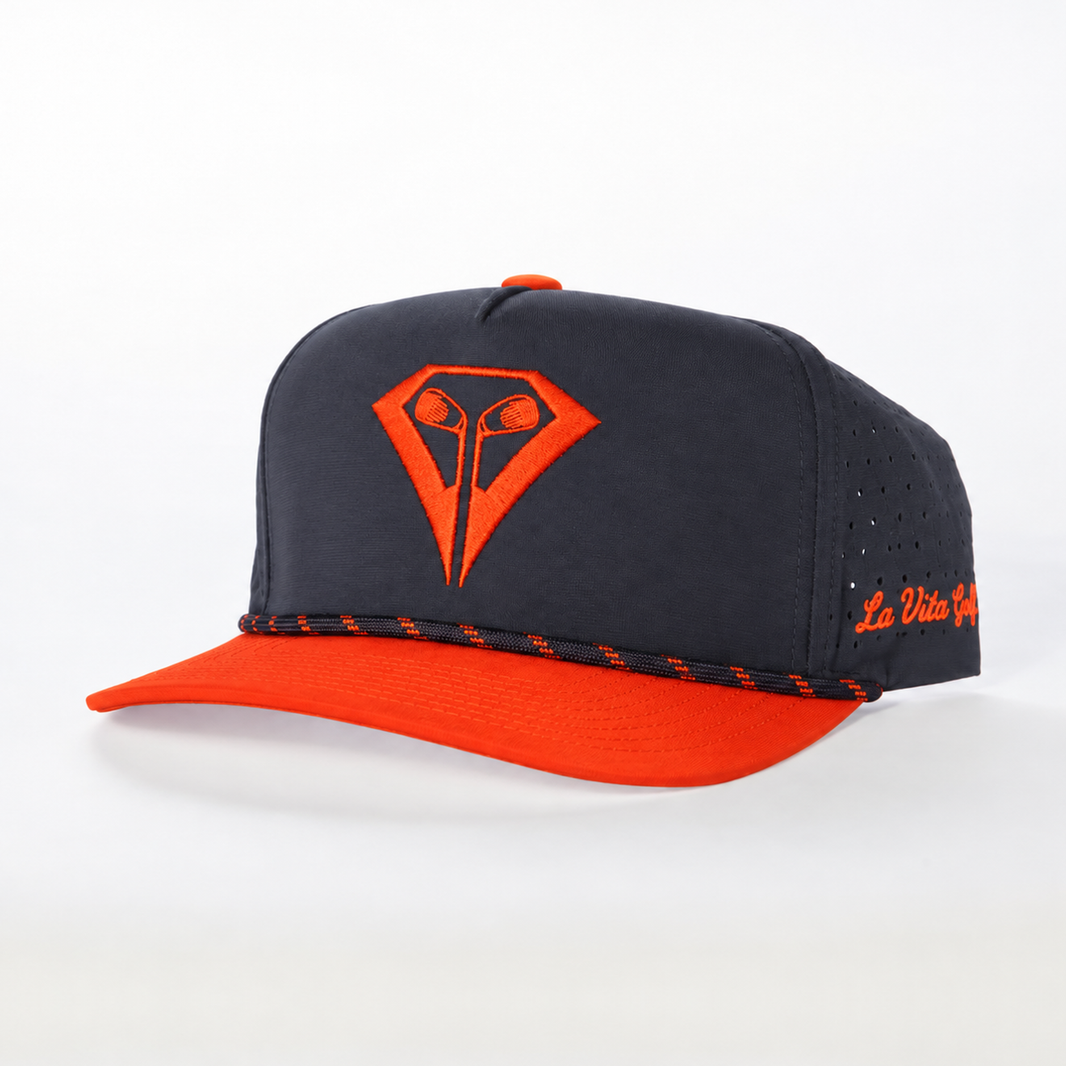 La Vita Golf Signature Rope Hat in Birdie Blaze – angled front view, navy crown with orange diamond logo and orange rope brim