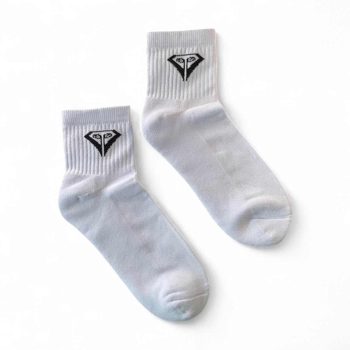 La Vita Golf Classic Crew Sock in White, pair laid flat, angled view of the black diamond crest and ribbed cuff.